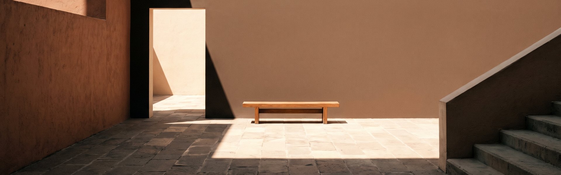 Muted plaster walls meet, a deep shadow line on stone floor, a sharp doorway of light, a staircase edge -- Superside alternatives.